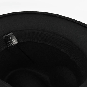 Detail view of the black wool felt jazz hat interior with 100% polyester size 57 label
