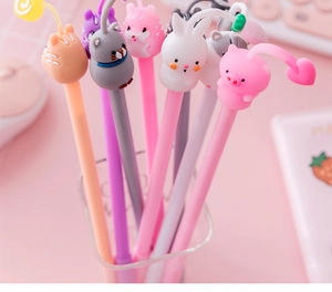 Close-up of cute 3D silicone animal figures on tops of colorful cartoon gel pens