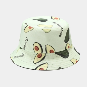 Close-up of light green cotton bucket hat featuring all-over avocado prints and text