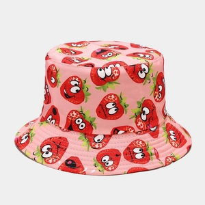 Detailed view of pink bucket hat featuring cartoon strawberry patterns and reinforced stitching