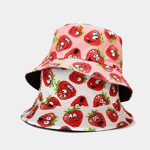 Detail of strawberry print bucket hat showing pink and white reversible patterns
