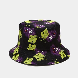 Detailed view of black bucket hat featuring playful purple grape cartoon prints and stitching