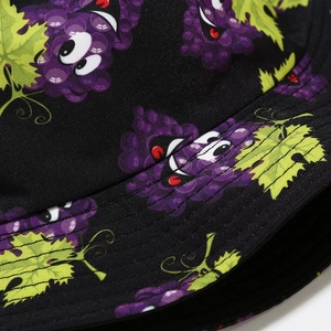 Detail shot of the black bucket hat with cartoon grape prints and high-quality stitching