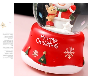 Detailed view of Christmas crystal ball with snowman, reindeer and Merry Christmas base