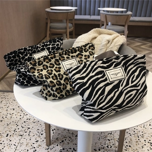 Three leopard and zebra print canvas cosmetic bags with Time to Party woven labels