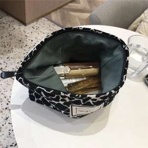 Close-up of leopard print canvas makeup bag with spacious interior for toiletries