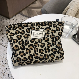 Detail of leopard print canvas toiletry bag with zipper and Time to Party label