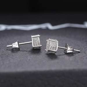 Macro shot of silver hip hop square stud earrings with micro-pave white zircon stones