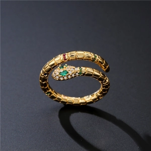Golden snake ring with green zircon eyes and micro-pave crystals in a wrap-around style