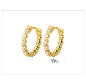 Detail shot of twisted gold hoop earring with white zircons, width 16.2mm measurement