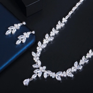 Macro detail of silver necklace and earrings set with marquise and pear-cut cubic zirconia