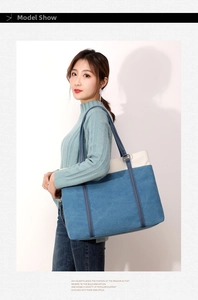 Detailed view of large canvas tote bag featuring blue and white contrast color blocks
