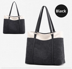 Detailed view of the large capacity canvas tote bag with black and cream color-blocking