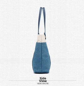 Side view of a vintage canvas tote bag with a blue and white color-block design