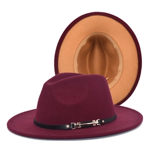 Detail of wide brim fedora hats in burgundy and khaki with black belt and gold buckle