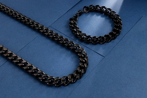 Detail of matte black titanium Cuban link chain necklace and bracelet jewelry set