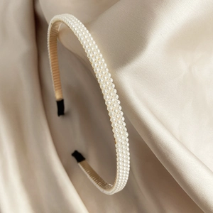 Elegante dunne haarband met witte faux parels en champagne stoffen voering