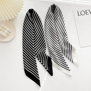 Detailed flat lay of black and white striped 70cm silk-like scarves on white background