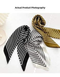 Close-up of three striped satin scarves with smooth silk texture and neat edge stitching
