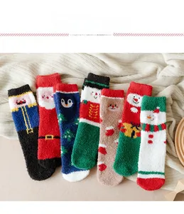 Flat lay of seven pairs of thick Christmas coral fleece socks with festive holiday patterns