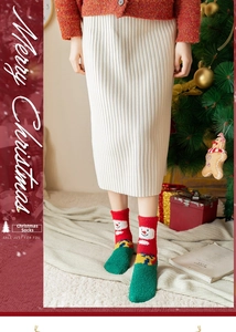 Close-up of fluffy Christmas socks with snowman pattern in a cozy holiday home setting