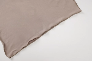 Detailed close-up showing grey knitted fabric texture and premium overlock stitching