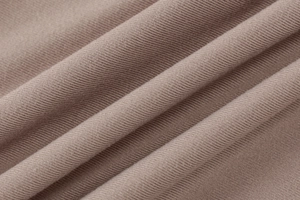 Detail shot of the mauve ribbed knit fabric showing soft texture and vertical patterns