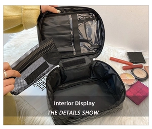 Detail showing inner compartments of black quilted cosmetic bag with mesh pouch