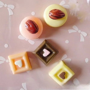 Macro detail of assorted resin chocolate and candy charms for DIY keychain making