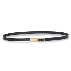 Slim black leather belt for women with rectangular gold buckle on white background