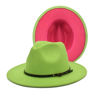 Detail view of contrast wool fedora hats in neon green and rose red with leather bands
