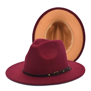 Detail of wool fedora showing red and camel contrast colors with black leather strap