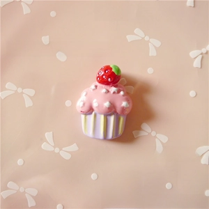 Detailed view of resin strawberry cupcake charm for DIY hair accessories and crafts