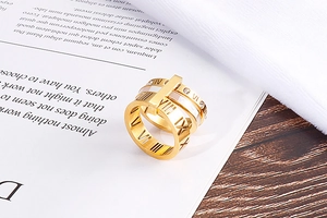 Detail of Roman numeral ring with white shell inlay and zircon accents on gold stainless steel