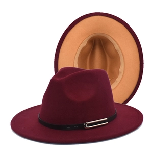 Detail of burgundy fedora hat with black leather belt and camel contrast brim interior