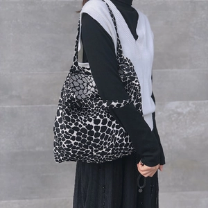 Minimalist black and white leopard print canvas tote bag with jacquard knit design