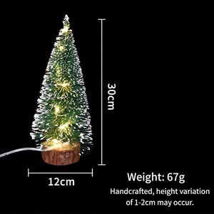 Detail of 30cm mini LED Christmas tree with snow-dusted needles and wooden base