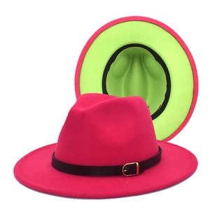 Detail of wool fedora hat with two-tone fuchsia and green brim and leather strap