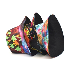 Three bucket hats with maple, abstract ink, and floral prints on a clean white background