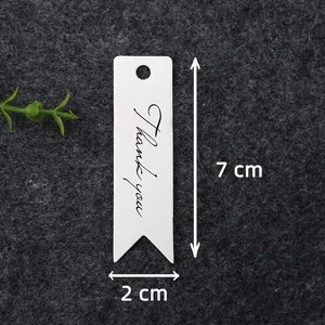 Close-up of 100 white kraft paper gift tags with black Thank You print and swallowtail cut