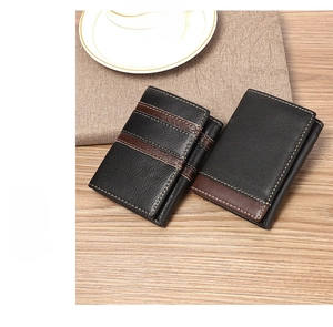 Close-up of trifold RFID leather wallets with litchi texture on wooden background