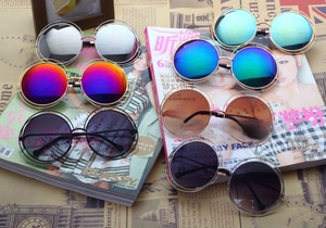 Flat lay of retro round metal sunglasses with colorful lenses and hollow double frames