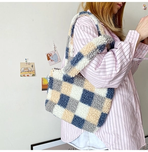 Detail of checkered plush tote bag with blue and beige shearling texture on shoulder