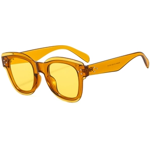 Retro amber frame sunglasses with yellow lenses and silver rivet studs on white background