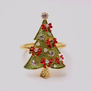 Detailed macro view of a golden Christmas tree napkin ring with green mesh and red bow