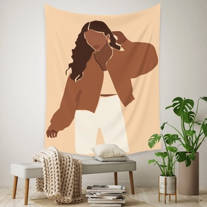 Detail view of Bohemian wall tapestry with abstract female illustration in minimalist room