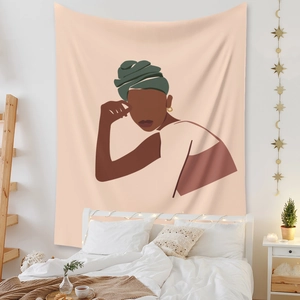 Detail of Bohemian tapestry with African woman art on a cozy bedroom background wall