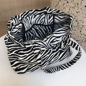 Detail view of the zebra print tote bag showing black inner lining and internal pocket