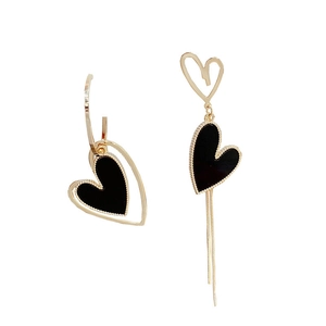 Asymmetric gold and black heart drop earrings with long tassel fringe on white background