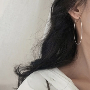 Close-up of model wearing large minimalist 925 sterling silver hoop earrings